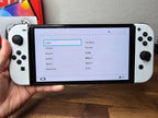 Nintendo Switch OLED 64GB + 128GB SD Handheld Console w/Joy-Con White & 5 Games 7K32