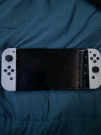 Nintendo Switch OLED with super smash bros and case 2S76